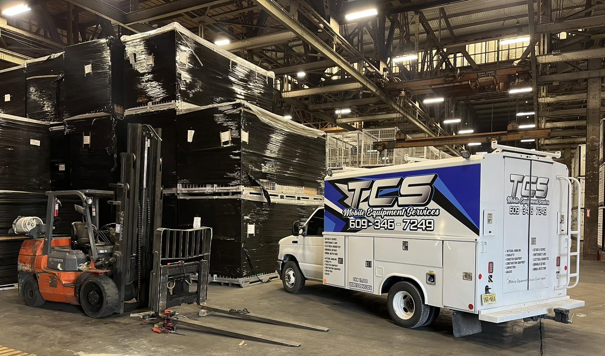 TCS mobile service truck beside a Toyota forklift at a customer facility